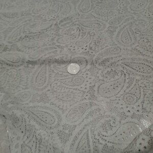 One final piece of stretch lace with a sand-colored paisley pattern fabric